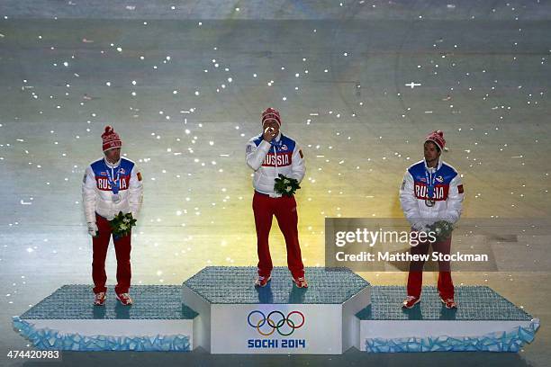 Silver medalist Maxim Vylegzhanin of Russia, gold medalist Alexander Legkov of Russia and bronze medalist Ilia Chernousov of Russia celebrate in the...