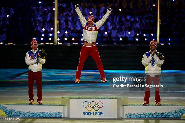Silver medalist Maxim Vylegzhanin of Russia, gold medalist Alexander Legkov of Russia and bronze medalist Ilia Chernousov of Russia celebrate during...