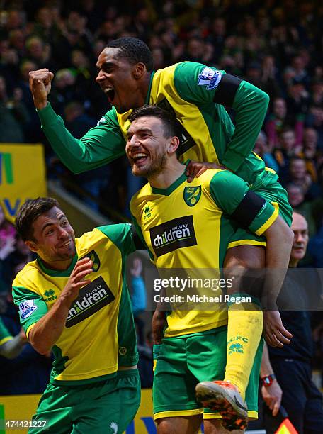 Robert Snodgrass of Norwich City celebrates scoring the opening goal with Leroy Fer and Russell Martin of Norwich City during the Barclays Premier...