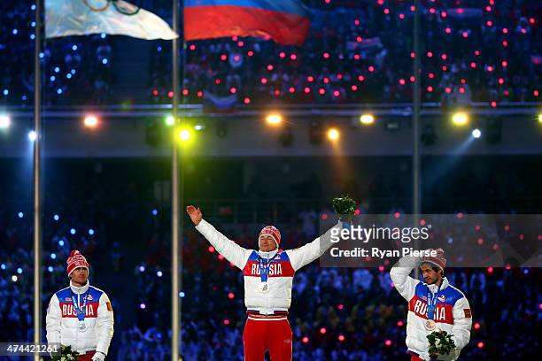 Silver medalist Maxim Vylegzhanin of Russia, gold medalist Alexander Legkov of Russia and bronze medalist Ilia Chernousov of Russia celebrate in the...
