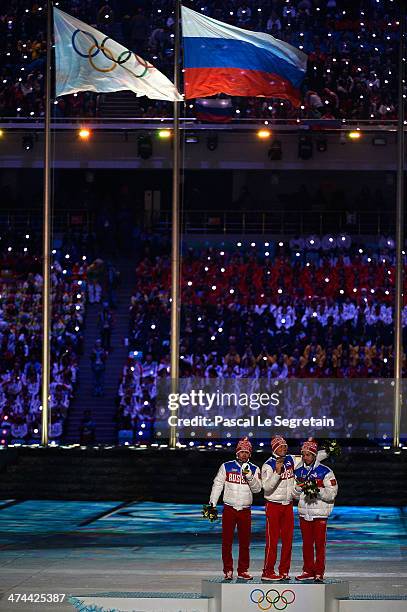 Silver medalist Maxim Vylegzhanin of Russia, gold medalist Alexander Legkov of Russia and bronze medalist Ilia Chernousov of Russia celebrate during...