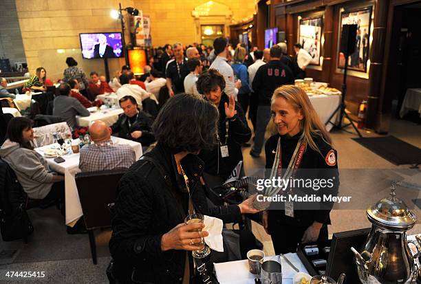 Donna Weinbrecht shows off her Olympic medal during the U.S. Olympic Committee's Team USA Club Event to celebrate the 2014 Winter Olympic Games at...