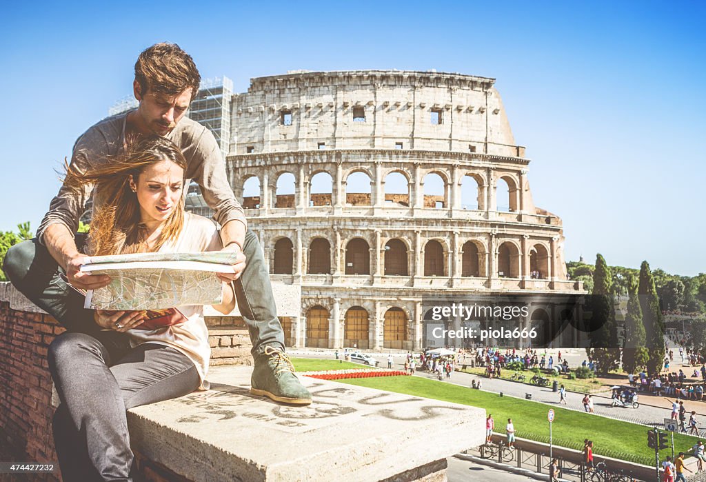 Tourists with  map in front of the Coliseum