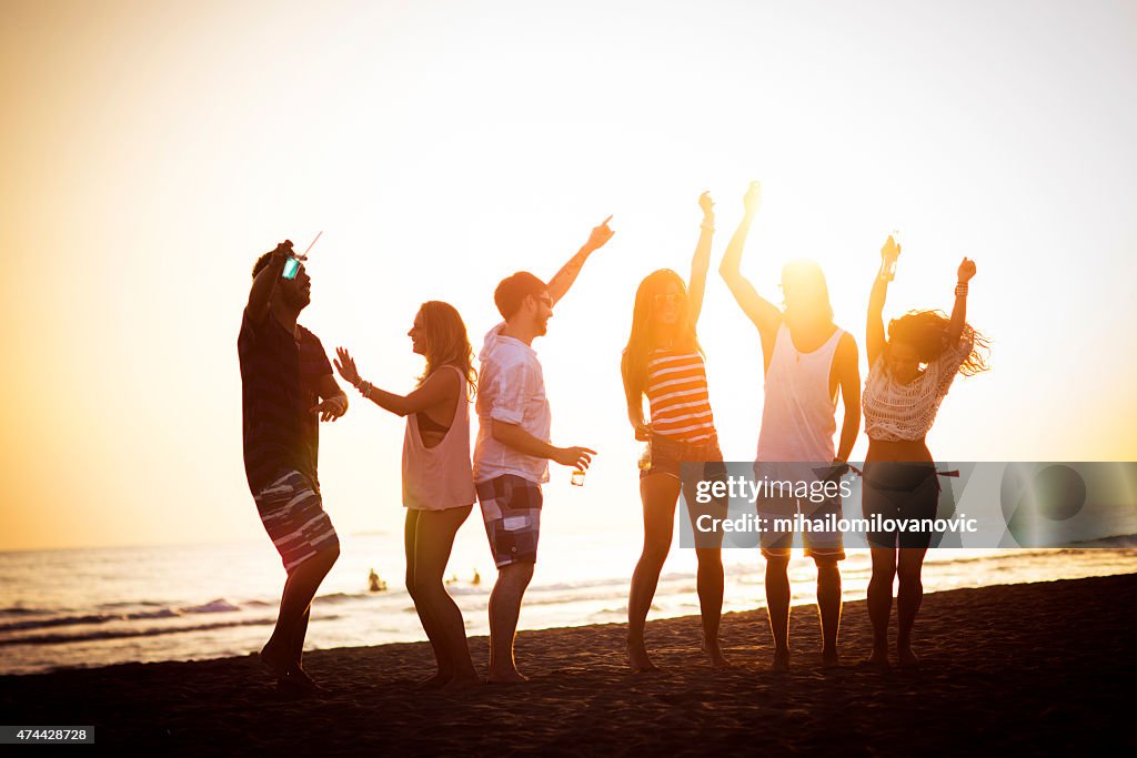 Friends dancing at the beach