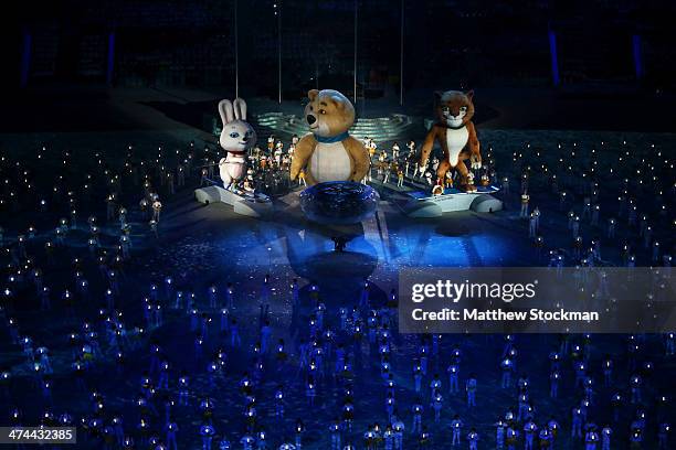 Olympic mascots the Hare, the Polar Bear and the Leopard stand by the extinguished Olympic flame during the 2014 Sochi Winter Olympics Closing...