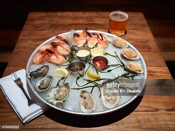 seafood platter on table with drink - seafood platter stock pictures, royalty-free photos & images