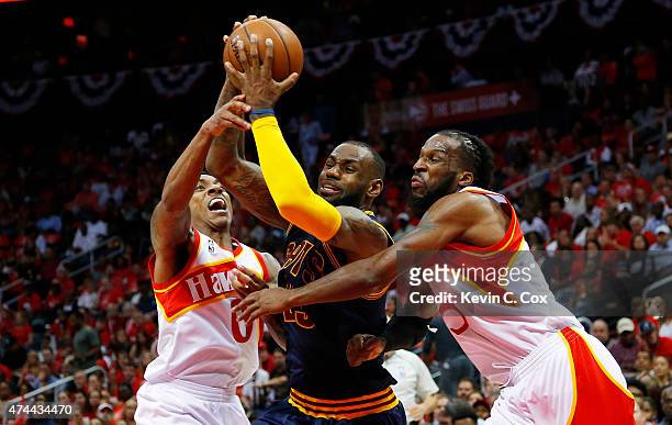 LeBron James of the Cleveland Cavaliers drives against DeMarre Carroll and Jeff Teague of the Atlanta Hawks in the second quarter during Game Two of...