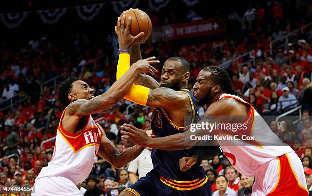 LeBron James of the Cleveland Cavaliers drives against Jeff Teague and DeMarre Carroll of the Atlanta Hawks in the second quarter during Game Two of...