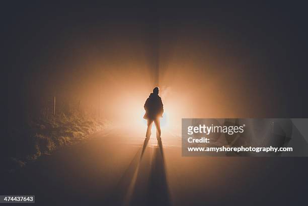 figure in fog - back lit people stock pictures, royalty-free photos & images