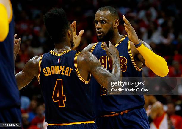 LeBron James celebrates with Iman Shumpert of the Cleveland Cavaliers after scoring in the second quarter against the Atlanta Hawks during Game Two...