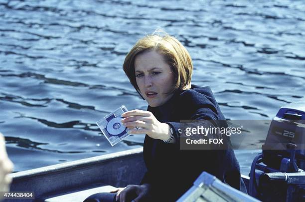 Agent Dana Scully holds a disk she believes contains the cure for cancer on THE X-FILES which originally aired Sunday, March 19, 2000 on FOX.