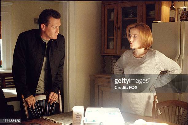 Agents John Doggett and Dana Scully discuss questions surrounding her pregnancy in the two-part season finale of THE X-FILES which originally aired...