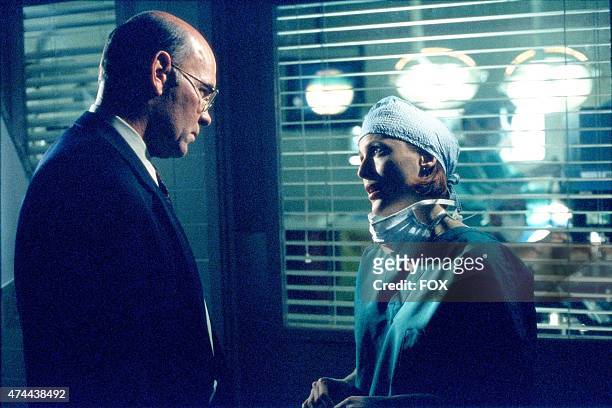 Assistant Director Skinner and Agent Dana Scully confer on a medical situation in THE X-FILES episode "Brand X" which originally aired April 16, 2000...