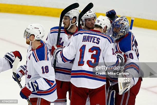 Henrik Lundqvist of the New York Rangers celebrates with his teammates after defeating the Tampa Bay Lightning 5 to 1 in Game Four of the Eastern...