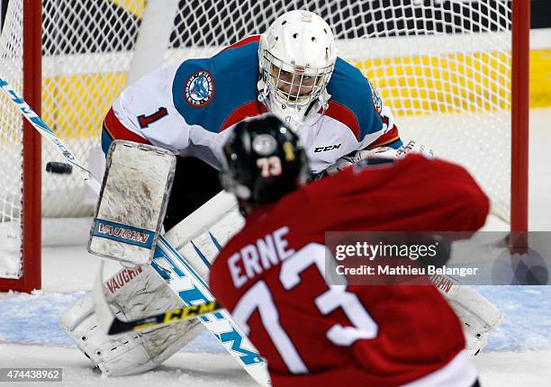 Adam Erne of the Quebec Remparts takes a shot on goalie Jackson Whistle of the Kelowna Rockets during the third period in Game One of the Memorial...