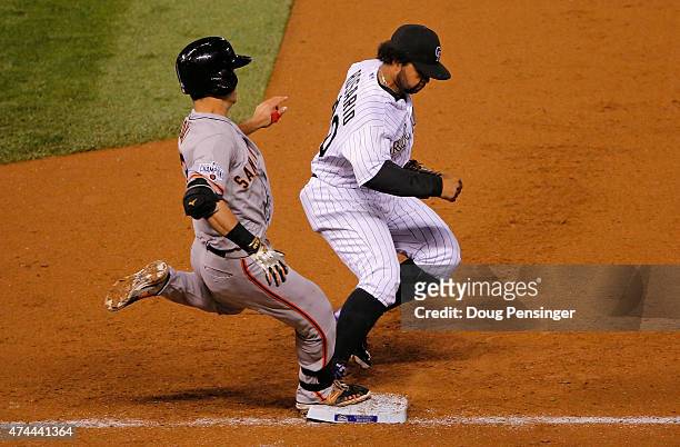 Nori Aoki of the San Francisco Giants grounds out as first baseman Wilin Rosario of the Colorado Rockies records an unassisted put out on the play in...
