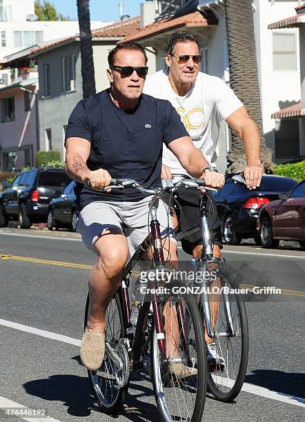 Arnold Schwarzenegger and Ralf Moeller are seen cycling on October 27, 2012 in Los Angeles, California.