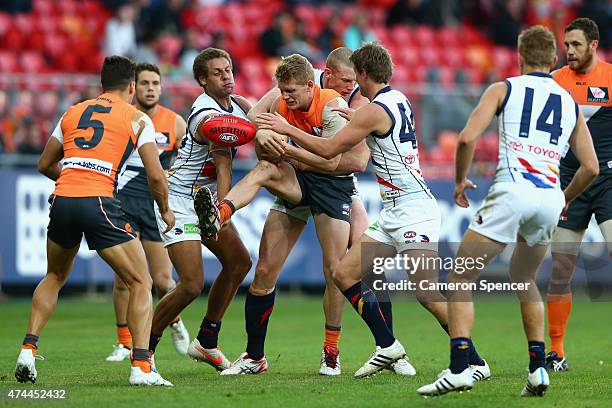 Adam Treloar of the Giants is tackled during the round eight AFL match between the Greater Western Sydney Giants and the Adelaide Crows at Spotless...