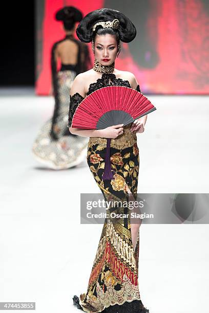 Model showcases designs by Anne Avantie on the runway during Indonesia Fashion Week 2014 day 4 at Jakarta Convention Center on February 23, 2014 in...