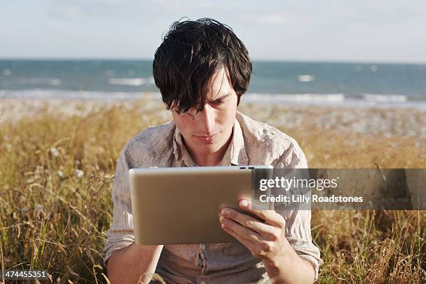 Guy Using Tablet 58 Man With Tablet By The Sea Stock Photos, High-Res Pictures, and ...