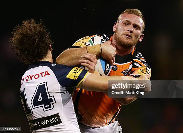 Matthew Lodge of the Tigers is tackled during the round 11 NRL match between the Wests Tigers and the North Queensland Cowboys at Campbelltown Sports...