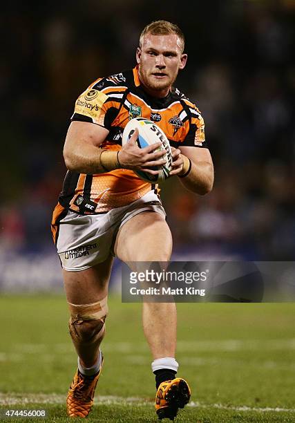 Matthew Lodge of the Tigers runs with the ball during the round 11 NRL match between the Wests Tigers and the North Queensland Cowboys at...