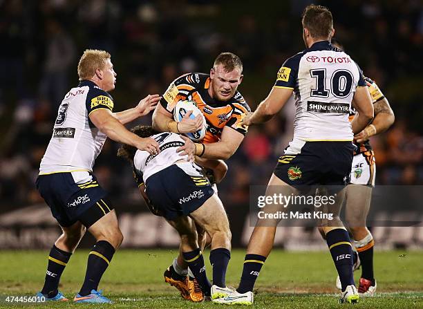 Matthew Lodge of the Tigers is tackled during the round 11 NRL match between the Wests Tigers and the North Queensland Cowboys at Campbelltown Sports...