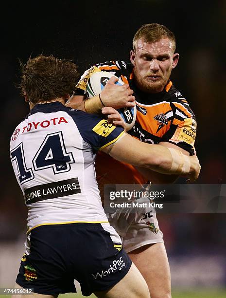 Matthew Lodge of the Tigers is tackled during the round 11 NRL match between the Wests Tigers and the North Queensland Cowboys at Campbelltown Sports...