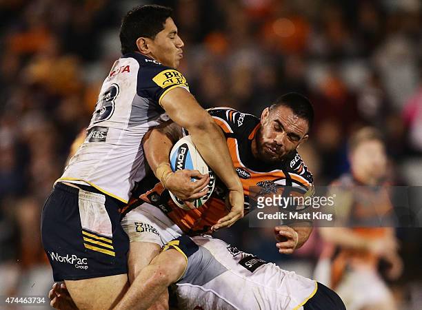 Dene Halatau of the Tigers is tackled during the round 11 NRL match between the Wests Tigers and the North Queensland Cowboys at Campbelltown Sports...