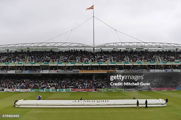 Ground staff put the hover cover over the pitch after during a rain delay on day three of the 1st Investec Test match between England and New Zealand...