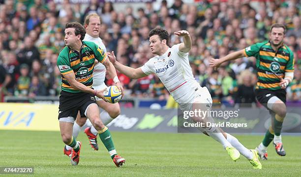 Lee Dickson of Northampton passes the ball as Duncan Taylor challenges during the Aviva Premiership play off semi final match between Northampton...