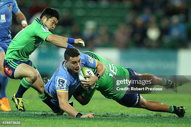 Kane Koteka of the Force is tackled by Fumiaki Tanaka of the Highlanders and Ash Dixon of the Highlanders during the Super Rugby round 15 match...