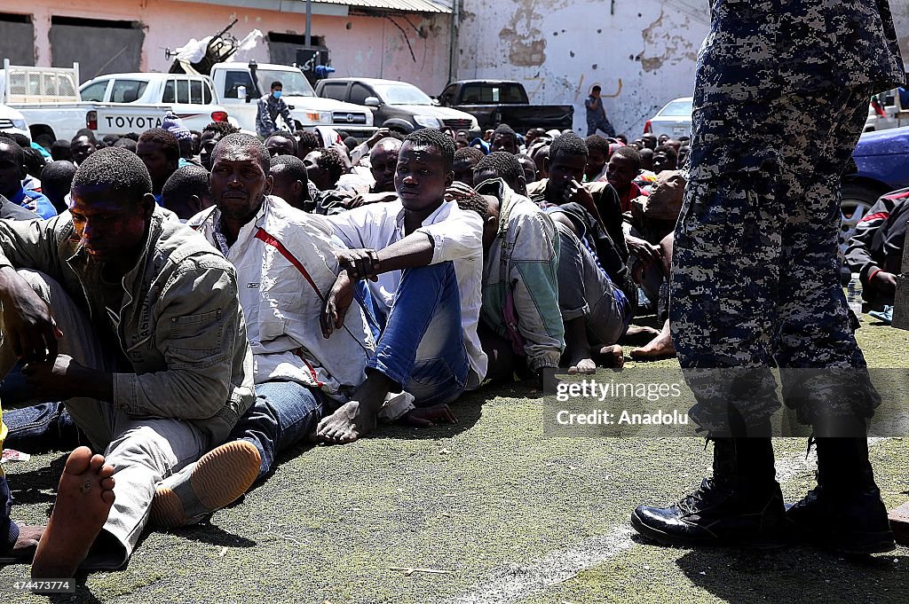 African Migrants sit at a center for illegal migrants in Tripoli