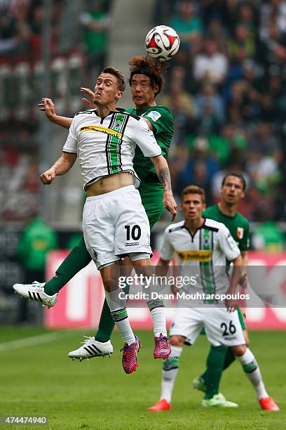 Max Kruse of Borussia Moenchengladbach and Hong Jeong-Ho of FC Augsburg battle for the header during the Bundesliga match between Borussia...