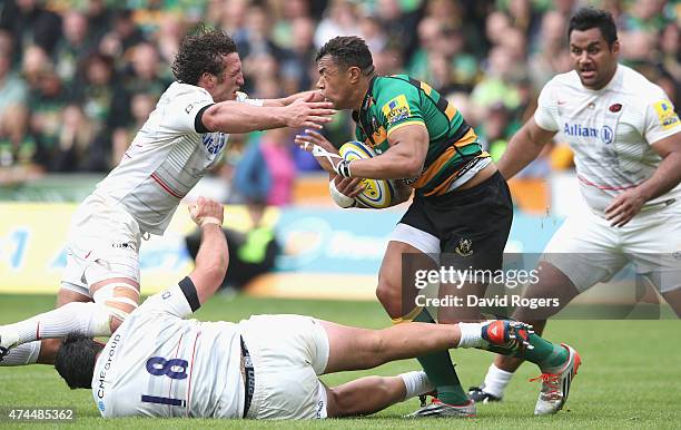 Jacques Burger of Saracens tackles Luther Burrell during the Aviva Premiership play off semi final match between Northampton Saints and Saracens at...