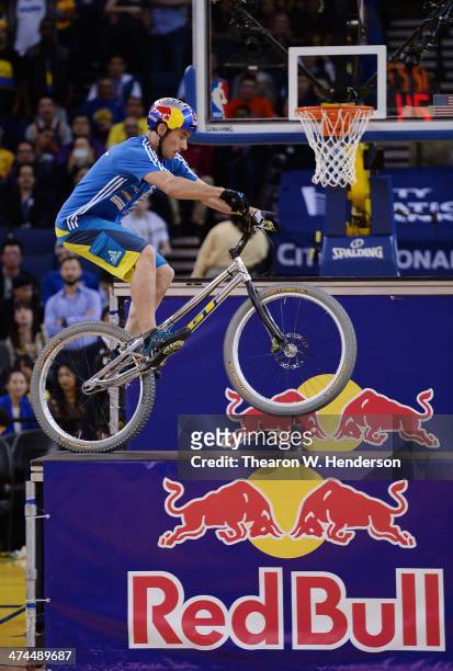 Kenney Belaey nick name "The Magician" and sponsored by Red Bull does bike tricks during half time of an NBA Basketball game between the Houston...