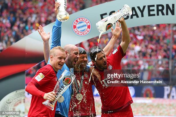 Sebastian Rode, Pepe Reina, Xabi Alonso and Claudio Pizarro of Bayern Muenchen celebrate following the Bundesliga match between FC Bayern Muenchen...