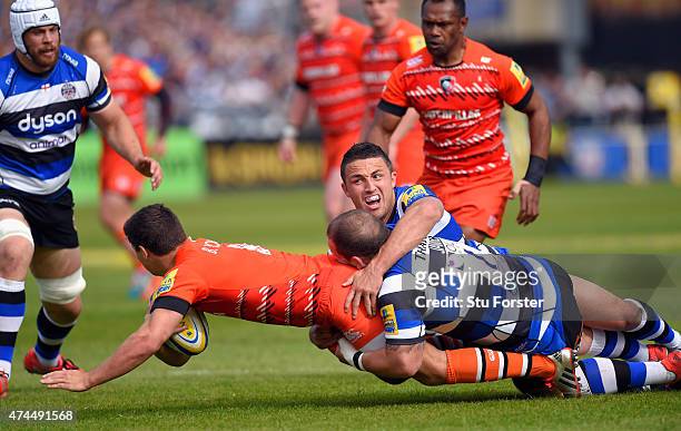 Bath player Sam Burgess and Paul James combine to tackle Tigers player Ben Youngs during the Aviva Premiership semi final match between Bath Rugby...