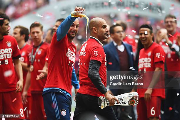 Josep Guardiola the head coach of Bayern Muenchen and Pepe Reina of Bayern Muenchen celebrate after winning the league during the Bundesliga match...