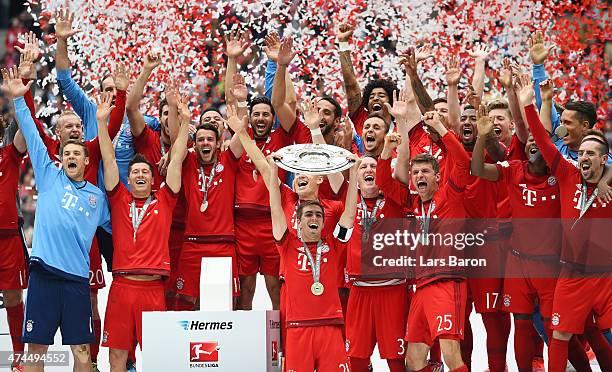 Captain Philipp Lahm of Bayern Muenchen lifts the Bundesliga trophy following the Bundesliga match between FC Bayern Muenchen and 1. FSV Mainz 05 at...