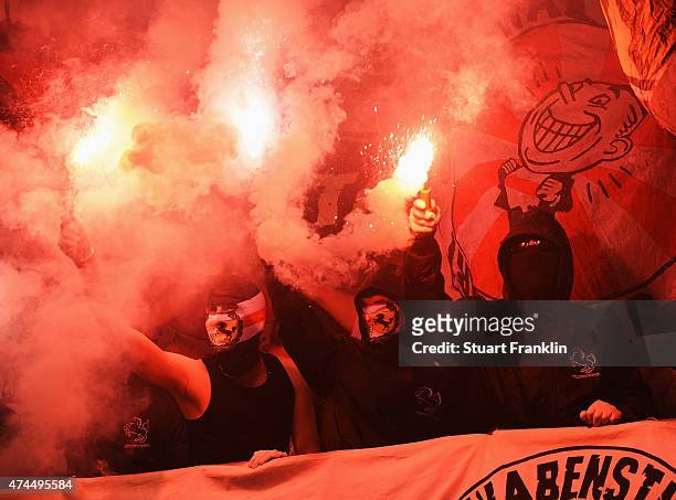 Fans of Stuttgart hold flares during the Bundesliga match between SC Paderborn 07 and VfB Stuttgart at Benteler Arena on May 23, 2015 in Paderborn,...