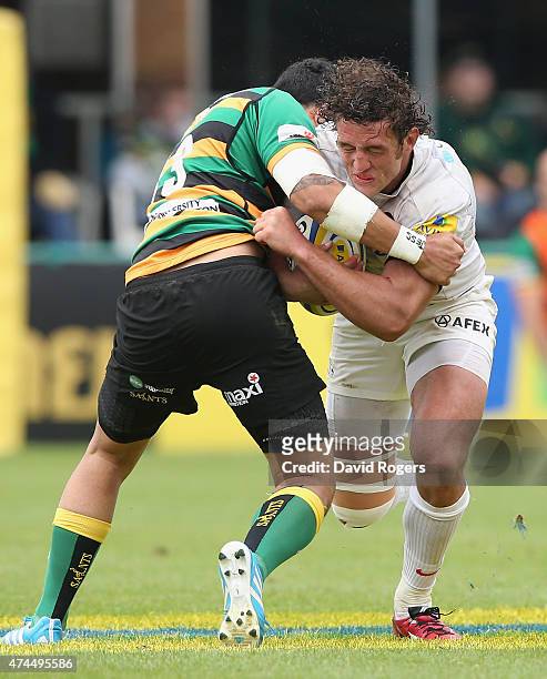 Jacques Burger of Saracens is tackled by George Pisi during the Aviva Premiership play off semi final match between Northampton Saints and Saracens...