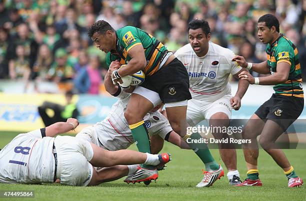 Jacques Burger and Juan Figallo of Saracens tackle Luther Burrell during the Aviva Premiership play off semi final match between Northampton Saints...