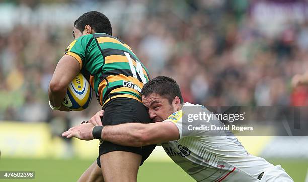 Ken Pisi of Northampton is tackled by Brad Barritt during the Aviva Premiership play off semi final match between Northampton Saints and Saracens at...
