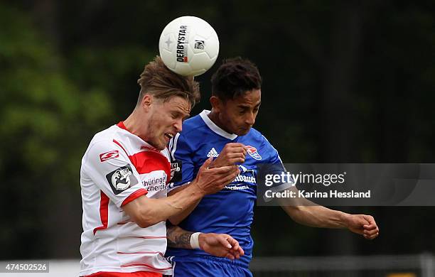 Sascha Eichmeier of Erfurt and Kenny Prince Redondo of Unterhaching jump for a header during the Third League match between FC Rot Weiss Erfurt and...