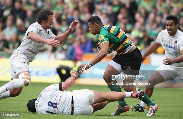 Jacques Burger and Juan Figallo of Saracens tackle Luther Burrell during the Aviva Premiership play off semi final match between Northampton Saints...