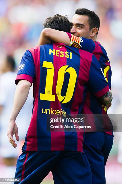 Lionel Messi of FC Barcelona is congratulated by his teammate Xavi Hernandez after scoring the opening goal during the La Liga match between FC...