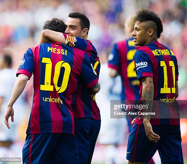 Lionel Messi of FC Barcelona is congratulated by his teammate Xavi Hernandez next to Neymar Santos Jr after scoring the opening goal during the La...