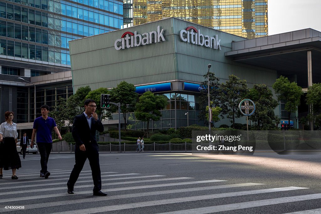 Pedestrians are walking past the crossroad in front of the...