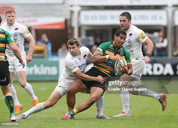 Ken Pisi of Northampton is tackled by Richard Wigglesworth during the Aviva Premiership play off semi final match between Northampton Saints and...